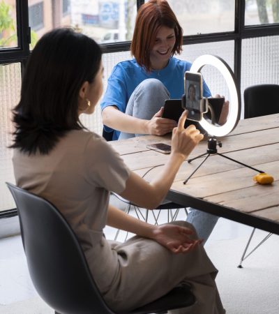 high-angle-women-with-phones-indoors (1)